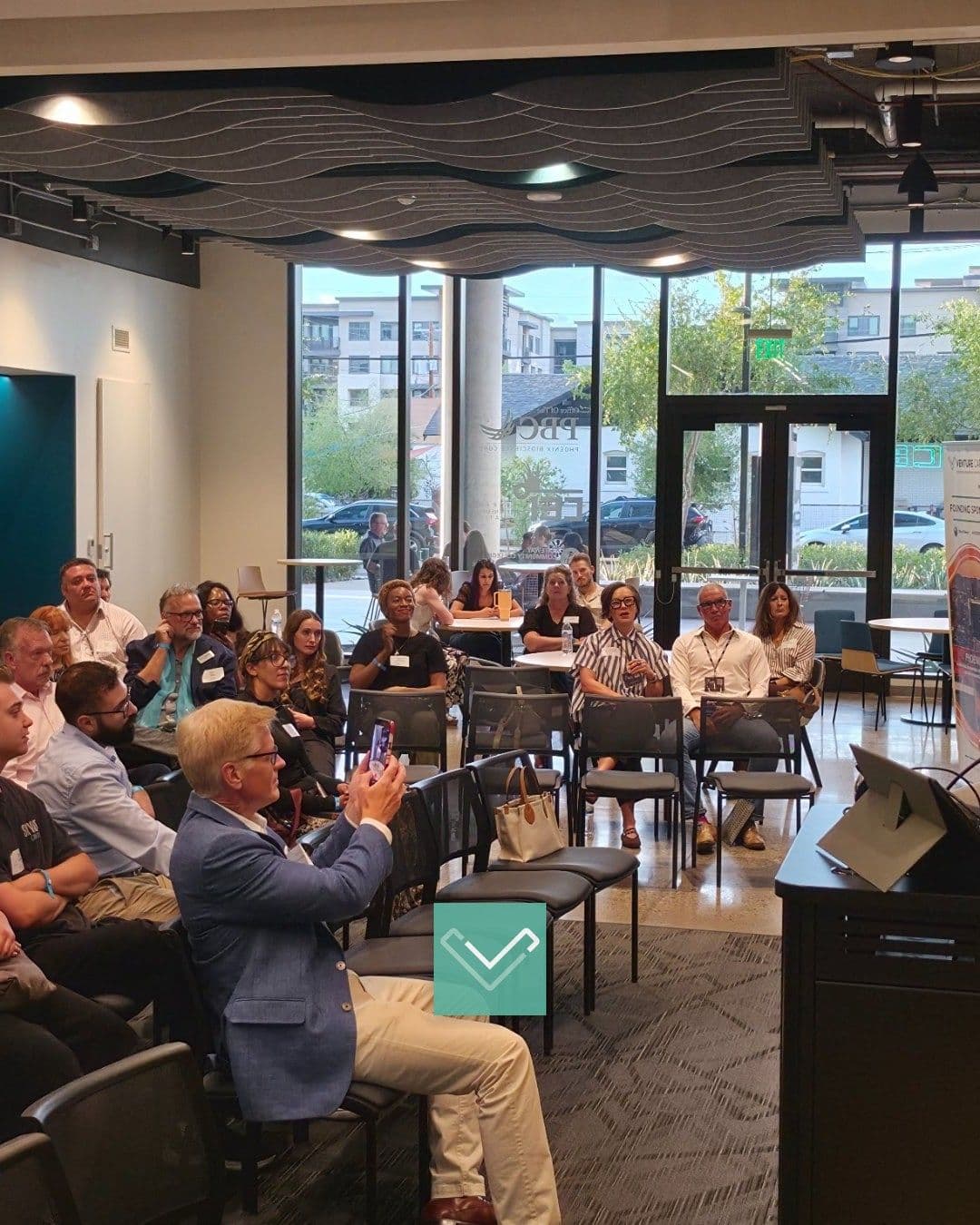 People seated and listening at a Venture Café Phoenix gathering.